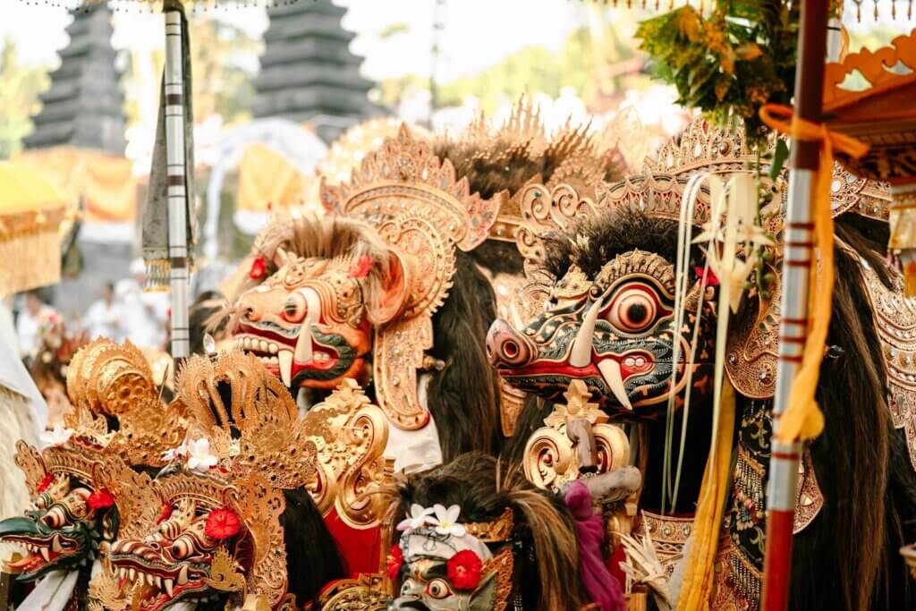 Traditional balinese masks and costumes displayed outdoors