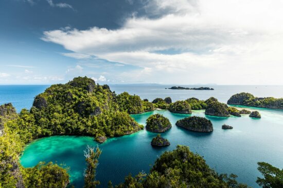 a group of small islands in the middle of a body of water