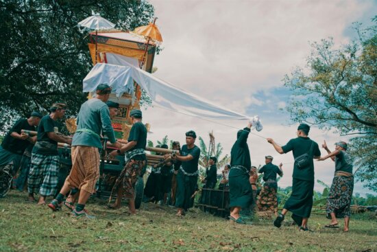 Men carry a large ornate structure outdoors